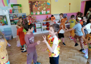 dzieci w strojach podczas zabawy na balu w sali przedszkolnej