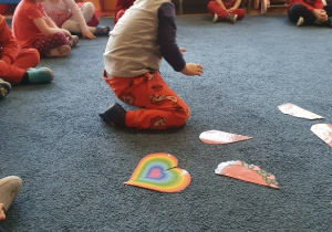 chłopiec na dywanie układa układankę